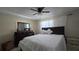Bedroom with queen bed, dresser, and natural light from the large window at 7813 Arabian Pl, Orlando, FL 32818