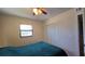 Bedroom featuring a neatly made bed, ceiling fan, and closet at 7813 Arabian Pl, Orlando, FL 32818