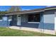 Exterior front view with blue brick facade and solar panels on the roof at 7813 Arabian Pl, Orlando, FL 32818