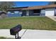 Charming single-story home with a well-maintained lawn and solar panels at 7813 Arabian Pl, Orlando, FL 32818