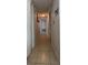 Hallway with neutral walls and tile flooring, leading to various rooms at 7813 Arabian Pl, Orlando, FL 32818