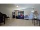 Cozy living room featuring tile flooring, a sofa, and a large mirror at 7813 Arabian Pl, Orlando, FL 32818