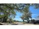 Street view of the neighborhood, lined with mature trees and well-kept homes at 7813 Arabian Pl, Orlando, FL 32818