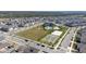 A sprawling community with a playground, pool, sports court, and expansive green space from above at 9747 Petition Way, Orlando, FL 32832