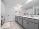 Elegant bathroom features a spacious vanity, dual sinks, and modern finishes at 9747 Petition Way, Orlando, FL 32832