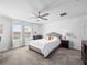 Inviting bedroom with a cozy bed, neutral color scheme, and ample natural light at 9747 Petition Way, Orlando, FL 32832