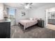 Bright bedroom boasts a large window, plush carpet, and contemporary decor at 9747 Petition Way, Orlando, FL 32832
