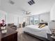 Bright bedroom features a ceiling fan, desk, view of a lake, and natural light at 9747 Petition Way, Orlando, FL 32832