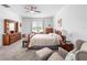 Spacious bedroom with neutral decor, a large window, and a comfortable seating area for relaxation at 9747 Petition Way, Orlando, FL 32832