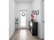Bright entryway with wood-look tile flooring and stylish decor at 9747 Petition Way, Orlando, FL 32832