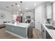 Spacious kitchen featuring a large island, stainless steel appliances, and stylish pendant lighting at 9747 Petition Way, Orlando, FL 32832