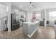 Modern kitchen with gray cabinets, stainless steel appliances, and a spacious center island at 9747 Petition Way, Orlando, FL 32832