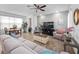 Open-concept living space with modern decor, a comfortable sofa, and a dining area for easy entertaining at 9747 Petition Way, Orlando, FL 32832
