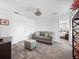 Cozy living room with a comfortable gray sofa, stylish ottoman, and neutral color palette at 9747 Petition Way, Orlando, FL 32832