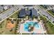 Aerial view of a community pool surrounded by palm trees, lounge chairs, and a playground at 9747 Petition Way, Orlando, FL 32832