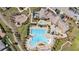Aerial view of resort-style pool with various amenities, playground, and lounge area at 9747 Petition Way, Orlando, FL 32832
