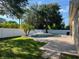 Private backyard oasis featuring a sparkling pool with a sun deck, lush landscaping, and a secure white fence at 4847 Lake Milly Dr, Orlando, FL 32839