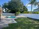 Enjoy the private backyard pool, beautifully landscaped with lush greenery and secured with a white privacy fence at 4847 Lake Milly Dr, Orlando, FL 32839