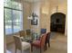 Bright dining area with a glass-topped table, seating for six, and view of the living room at 4847 Lake Milly Dr, Orlando, FL 32839
