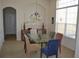 Bright dining room featuring glass table, chandelier, neutral walls, and large window providing natural lighting at 4847 Lake Milly Dr, Orlando, FL 32839