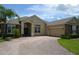 Beautiful home showcasing a brick paver driveway leading to an attached two-car garage at 4847 Lake Milly Dr, Orlando, FL 32839