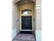 Elegant double front doors with transom window and brick accents at 4847 Lake Milly Dr, Orlando, FL 32839
