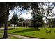 Beautiful home with manicured lawn and mature trees providing shade at 4847 Lake Milly Dr, Orlando, FL 32839