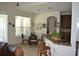 Cozy breakfast nook with a glass table, barstool seating at the granite countertop, and natural light at 4847 Lake Milly Dr, Orlando, FL 32839