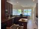 Beautiful kitchen featuring dark wood cabinetry, granite countertops, and views of the pool area at 4847 Lake Milly Dr, Orlando, FL 32839