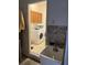 Functional laundry room with washer, dryer, sink, and storage cabinets at 4847 Lake Milly Dr, Orlando, FL 32839