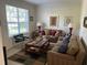 Cozy living room featuring neutral-toned furnishings, a patterned rug, and ample natural light at 4847 Lake Milly Dr, Orlando, FL 32839