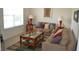 Comfortable living room featuring two sofas, a glass-topped coffee table, and natural light from a large window at 4847 Lake Milly Dr, Orlando, FL 32839