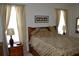 Bedroom featuring a large bed, side tables, and plenty of natural light from two windows at 4847 Lake Milly Dr, Orlando, FL 32839