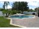 Beautiful pool and patio area, perfect for relaxation and outdoor entertaining with lush tropical landscaping at 4847 Lake Milly Dr, Orlando, FL 32839