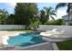 Backyard with pool, patio, lounge chairs, and lush tropical landscaping at 4847 Lake Milly Dr, Orlando, FL 32839