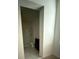 Bathroom view showing the vanity, toilet, and partial shower area with neutral tile at 124 Sofia Ln, Lake Alfred, FL 33850