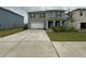 Charming two-story home with a large driveway, attached garage, and covered porch at 124 Sofia Ln, Lake Alfred, FL 33850