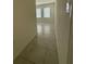 Hallway featuring tile floors and an entrance to the room with windows at 124 Sofia Ln, Lake Alfred, FL 33850