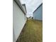 Side yard showcasing the house's exterior and landscaping, offering a glimpse of the property's surroundings at 124 Sofia Ln, Lake Alfred, FL 33850