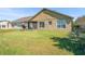 Spacious backyard featuring a well-maintained lawn and a view of the home's exterior at 12824 Penshurst Ln, Windermere, FL 34786