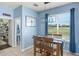Cozy dining area with natural light and view to the backyard and half bath at 12824 Penshurst Ln, Windermere, FL 34786