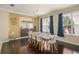 Bright dining room featuring a wine rack, modern chandelier, and large windows with blue drapes at 12824 Penshurst Ln, Windermere, FL 34786