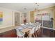 Open concept dining room boasts dark wood floors, a wine rack, and contemporary lighting at 12824 Penshurst Ln, Windermere, FL 34786