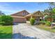 Charming single-story home with a well-manicured lawn and attached two-car garage at 12824 Penshurst Ln, Windermere, FL 34786