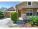 Inviting covered front porch with stone accents, lush plants, and seating area for relaxing at 12824 Penshurst Ln, Windermere, FL 34786