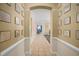 Bright hallway featuring tiled flooring and decor, leading to various areas of the house at 12824 Penshurst Ln, Windermere, FL 34786