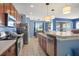 Well-lit kitchen with stainless appliances, wood cabinetry, and an adjacent dining area at 12824 Penshurst Ln, Windermere, FL 34786