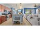 Open kitchen and living area with stainless appliances, pendant lighting, and comfortable seating at 12824 Penshurst Ln, Windermere, FL 34786