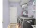 Functional laundry room with modern washer and dryer, shelving, and amusing wall decor at 12824 Penshurst Ln, Windermere, FL 34786