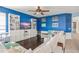 Spacious living room features blue accent wall, built in shelving and dark wood floors at 12824 Penshurst Ln, Windermere, FL 34786